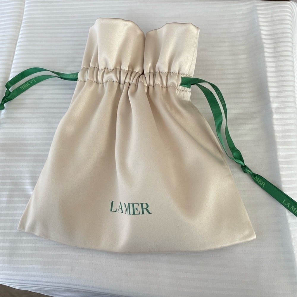 La Mer. Cream Satin Pouch. New, unused.Great for makeup, jewelry, or accessories
